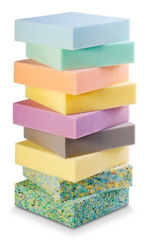 Stack of colorful foam mattress layers in various sizes