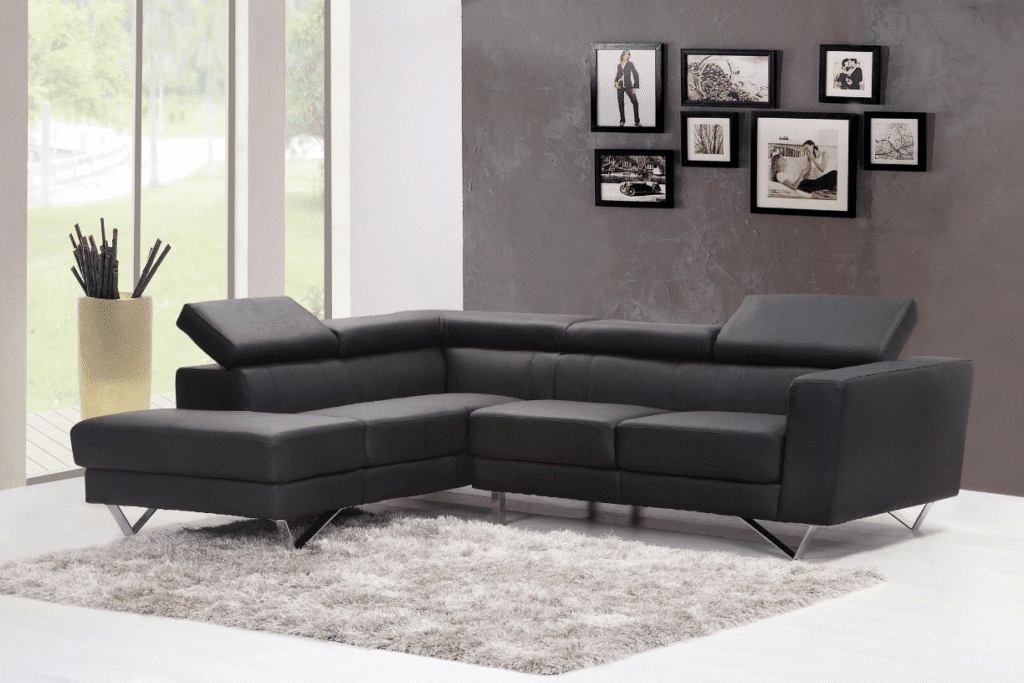Modern black L-shaped sofa with adjustable headrests in living room