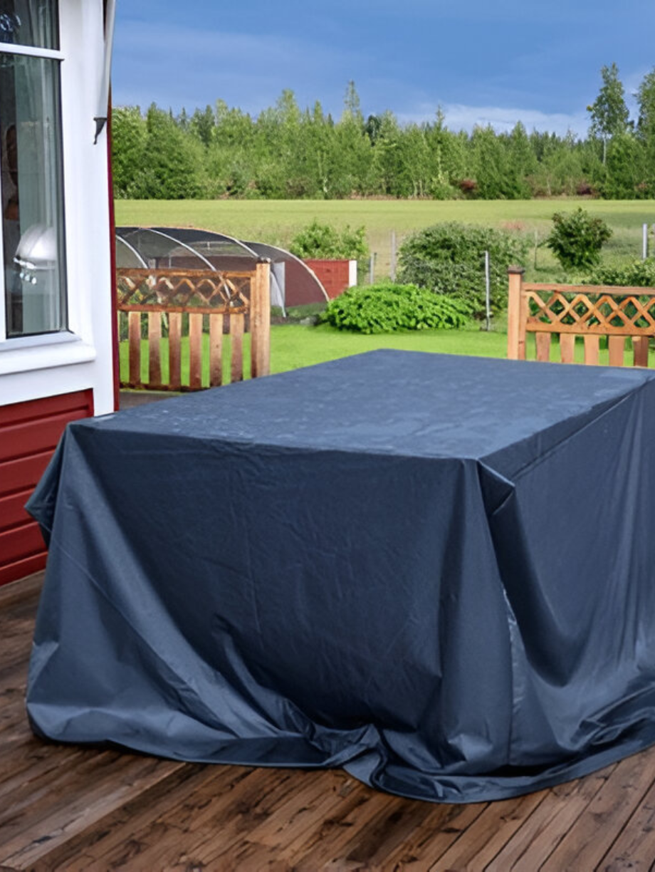 Outdoor table covered with a dark grey protective cover