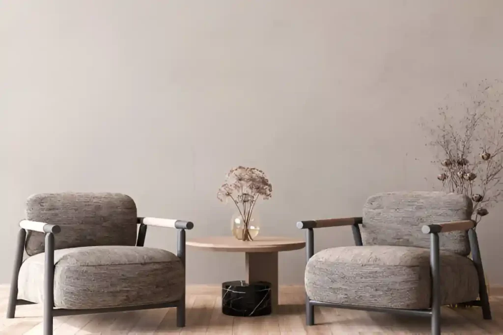 Minimalist lounge setup with two grey armchairs and wooden coffee table