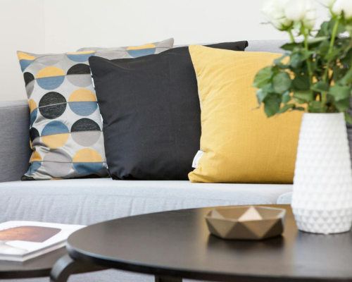 Modern living room with decorative pillows and a minimalist coffee table