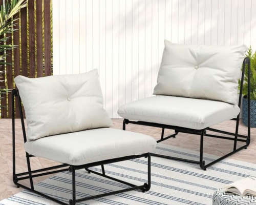 Modern outdoor lounge chairs with white cushions on a patio