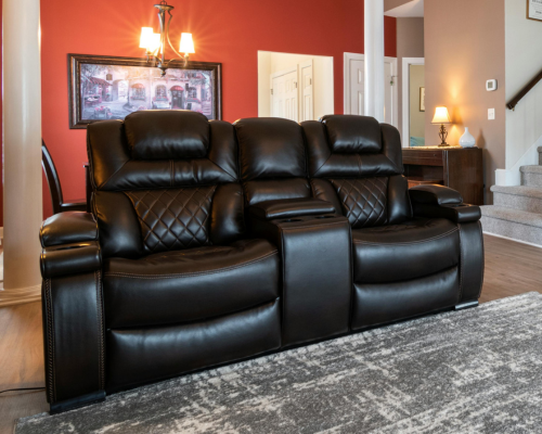Black leather reclining sofa with quilted design in modern living room