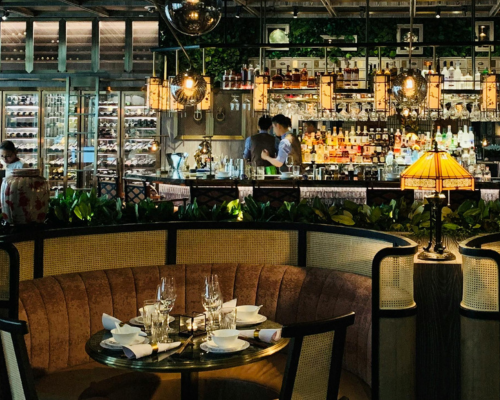 Cozy restaurant booth with elegant table setting and ambient lighting