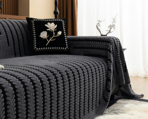 Dark grey textured sofa cover with embroidered black floral pillow