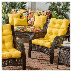 Outdoor wicker furniture with yellow cushions and floral sofa