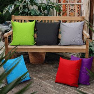 Wooden bench with colorful cushions in garden setting
