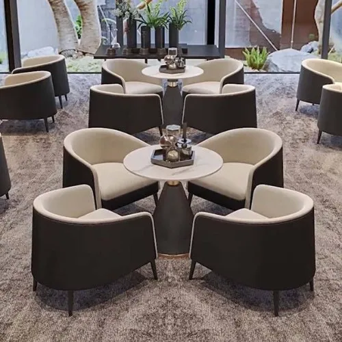 Modern lounge area with round tables and beige upholstered chairs