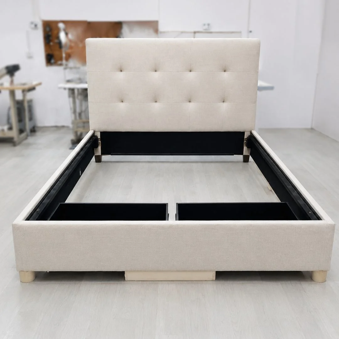 Modern upholstered bed with a tall tufted headboard in beige fabric, displayed in a bright, minimalist indoor workshop setting, showcasing premium fabric choice for bed upholstery.